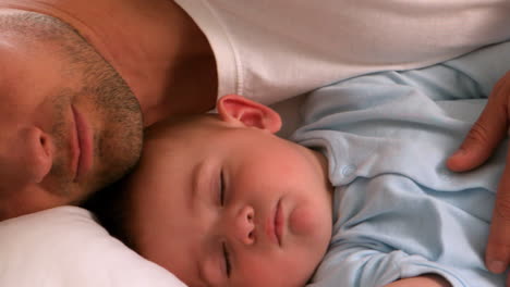 Father-lying-with-his-sleeping-baby-