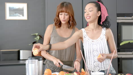 Two-biracial-women-cook-in-modern-kitchen