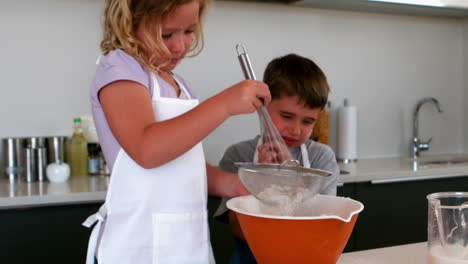 Siblings-sieving-flour-into-a-bowl