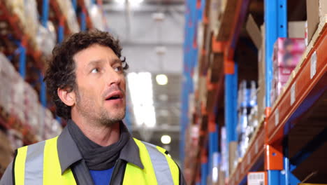 Warehouse-worker-looking-the-shelves-