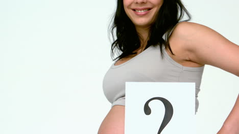 Pregnant-woman-holding-question-mark-over-her-belly