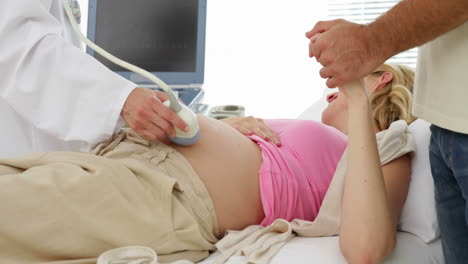 Blonde-pregnant-woman-having-a-sonogram-scan