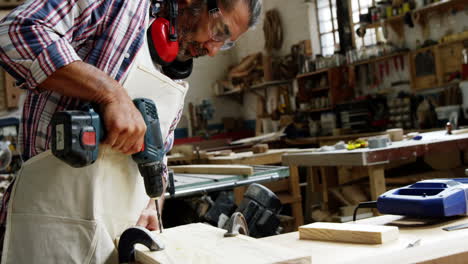 Side-view-of-concentrated-carpenter-drilling