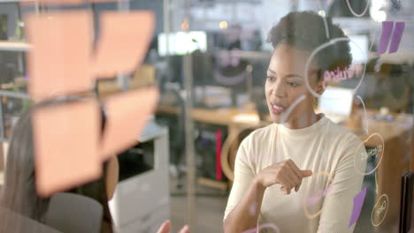 Two-businesswomen,-one-biracial-and-one-African-American,-discussing