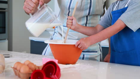 Happy-father-and-son-making-a-cake-together