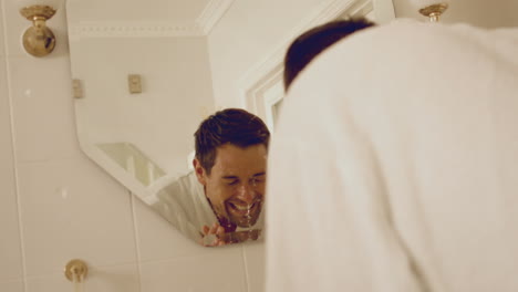 Man-washing-his-face-in-sink