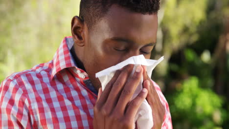 Portrait-of-man-is-blowing-his-nose-