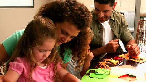 Parents-and-children-making-paper-shapes-together-at-the-table