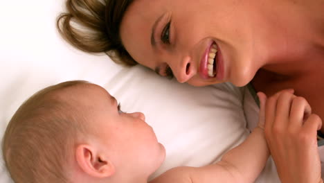 Cute-baby-on-a-bed-with-mother