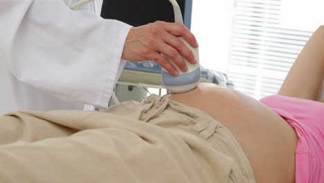 Blonde-pregnant-woman-having-a-sonogram-scan