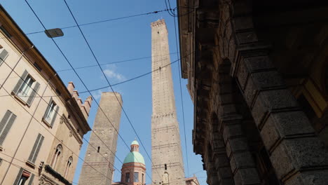 Historic-towers-rise-above-Bologna's-old-town-streets-under-a-clear-sky