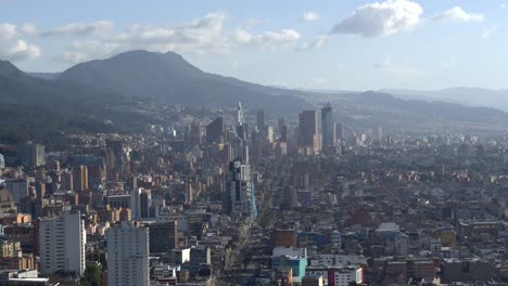 Drone-shot-of-downtown-Bogota,-Colombia-from-afar-at-sunset