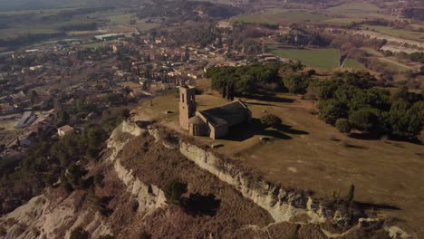 Historic-hermitage-on-a-hill-overlooking-Tona,-Barcelona,-scenic-aerial-view