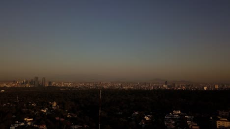 360-aerial-shot-of-Mexico-City-in-sunset,-buildings,-pollution,-and-green-areas