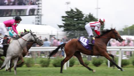 Capture-the-thrilling-moments-of-a-turf-race-at-Churchill-Downs,-as-horses-thunder-down-the-track-in-a-display-of-speed-and-agility