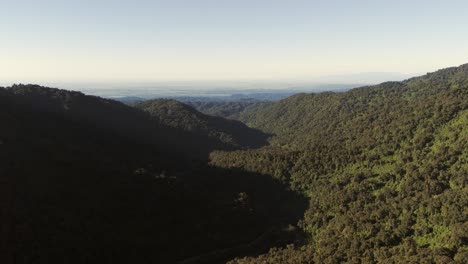 Panoramic-aerial-view-of-a-sunset-over-the-Yunga-forest-of-Tucumán,-with-the-plains-in-the-background