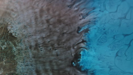 Blue-ink-merging-with-brown-ink-in-water-creates-mesmerizing-abstract-patterns
