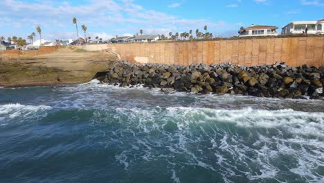 Coastal-View-of-Rocky-Shoreline-and-Seawall-in-San-Diego,-California,-golden-hour-view