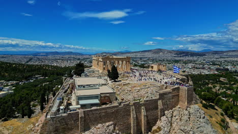 Aerial-establisher-acropolis-in-Athen,-famous-landmark-crowded-with-tourists