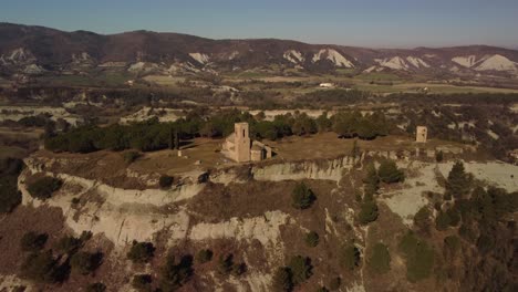 Hermitage-and-town-of-tona-surrounded-by-scenic-hills-and-countryside,-aerial-view