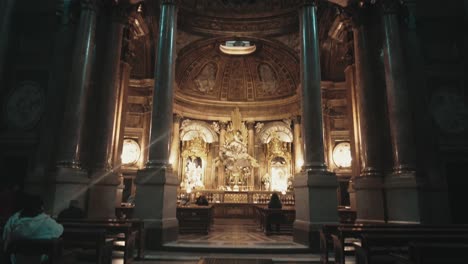 wide-angle-people-praying-wide-angle-altar-of-Jesus-christ-on-the-cros-in-giant-cathedral-church-in-Zaragoza