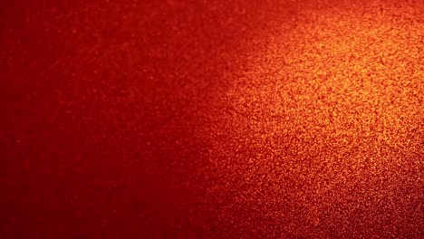 Red-particles-against-orange-background