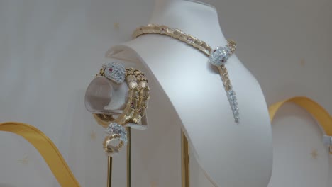 Exquisite-snake-themed-gold-and-diamond-jewelry-set-displayed-elegantly-in-a-boutique