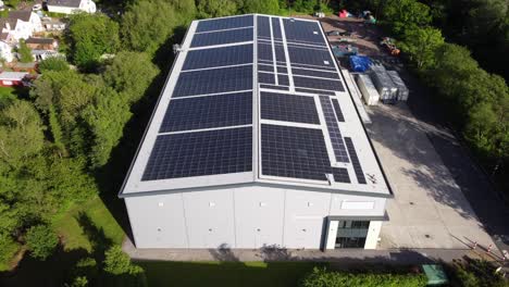 Drone-flying-over-commercial-property-building-with-large-solar-panels