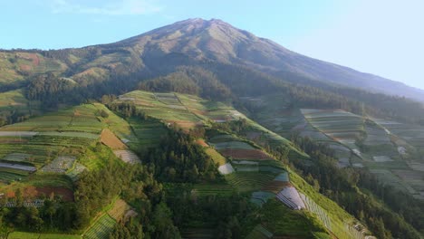Drone-sideways-volcano-Sumbing-in-Indoensia,-establisher-sunny-evening