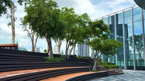 Beautiful-garden-with-big-trees-and-long-wooden-bench-on-the-rooftop-of-Samyan-Mitrtown-building