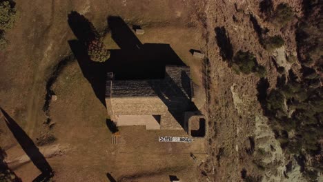 Hermitage-and-town-of-tona-in-barcelona-during-the-day-with-long-shadows,-aerial-view