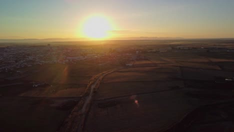 Sunrise-over-pozoblanco,-a-town-in-cordoba,-with-sprawling-fields-and-morning-light,-aerial-view