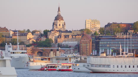 Telephoto-view-of-Katarina-church-of-Sweden-on-skyline-as-ferry-pass-by