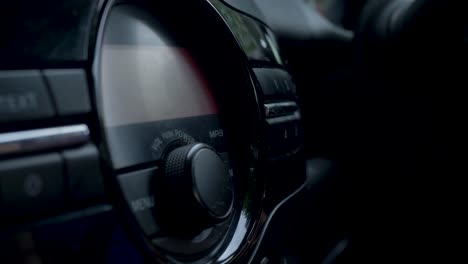 Slow-motion-shot-of-driver-using-hands-to-press-button-on-car-stereo-sound-system-vehicle-audio-electronics-entertainment-radio-head-unit