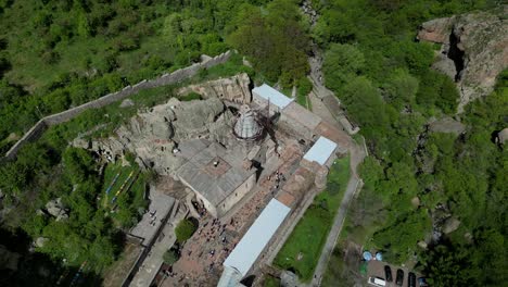 4K-drone-shot-of-the-Geghard-Monastery-tourist-site-in-Armenia-close-to-Yerewan