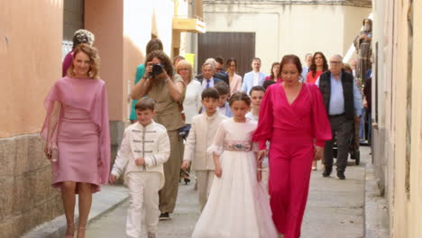 Adults-Walking-Children-During-Communion-Celebration,-Spain