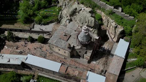 Close-up-drone-shot-of-the-restoration-work-at-Geghard-Monastery-UNESCO-World-Heritage-site-in-Armenia-close-to-Yerewan