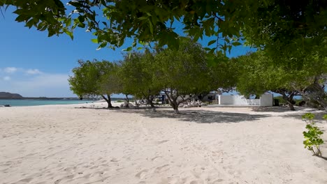 Beachfront-house-open-concept-living-area-with-expansive-windows-that-frame-panoramic-ocean-view