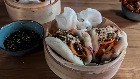 Steamed-filled-bao-buns-oriental-chinese-meal-prawn-crackers-and-sesame-soy-sauce