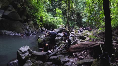 Group-of-people-sightseeing,-exotic-serene-humid-forest-environment