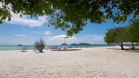 Lounge-by-sparkling-caribbean-pristine-beach,-on-white-sand-in-a-private-oasis-of-tranquility