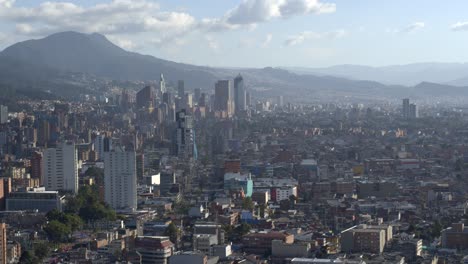 Drone-shot-of-downtown-Bogota,-Colombia-from-afar-on-sunny-day