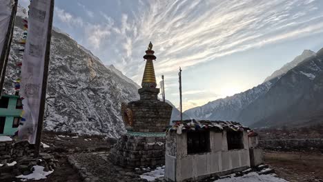 Stone-enlightenment-Stupa-in-front-of-towering-Himalayan-mountain-during-sunset-in-Nepal