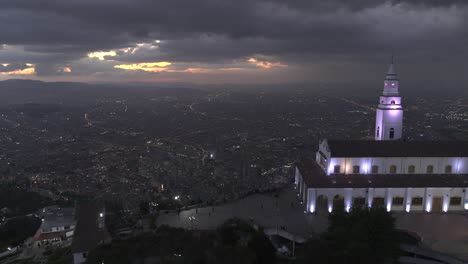 Drone-shot-of-Monserrate-church-overlooking-the-city-of-Bogota,-Colombia-at-sunset