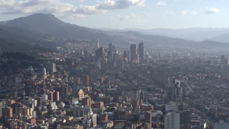 Drone-shot-of-downtown-Bogota,-Colombia-from-afar-on-sunny-day