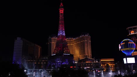 Las-Vegas-Strip-Skyline-at-Night,-Bellagio-Music-Fountain-and-Shiny-Casino-Hotel-Buildings