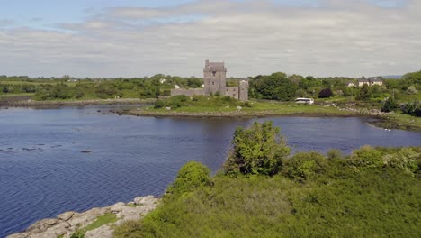 Aerial-tracking-shot-of-Dunguaire-Castle-on-a-sunny-day