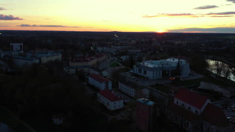 Sunset-Over-Valmiera-with-Distant-Horizon-and-Buildings-in-Aerial-view