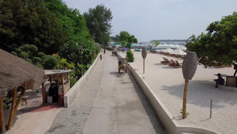 Aerial-tilt-down-shot-of-a-taxi-carriage-with-a-horse-in-Gili-Trawangan-in-Bali