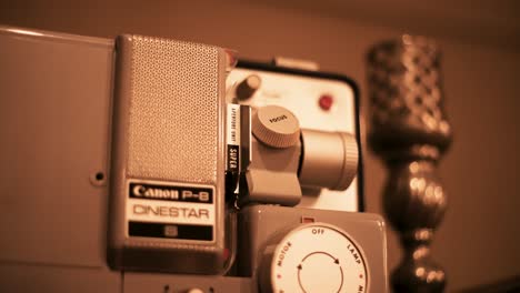 Vintage-retro-8mm-projector-with-defocus-candle-holder-with-truck-camera-movement-4K